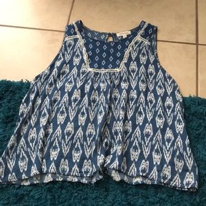 Sleeveless blue and white printed blouse